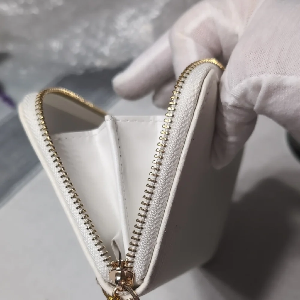 bebe White Zip Wristlet Clutch with Gold Logo
